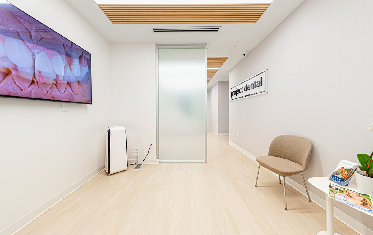 Modern waiting area at Project Dental in Rockville, MD with TV showing dental images